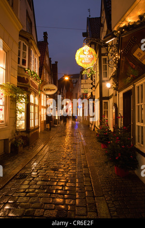 Germany, Bremen, People in alley at night Stock Photo