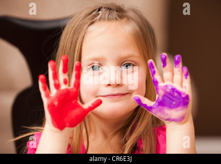 Girl (4-5) with paint covered hands Stock Photo