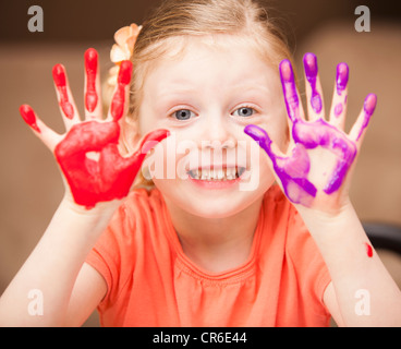 Girl (4-5) with paint covered hands Stock Photo