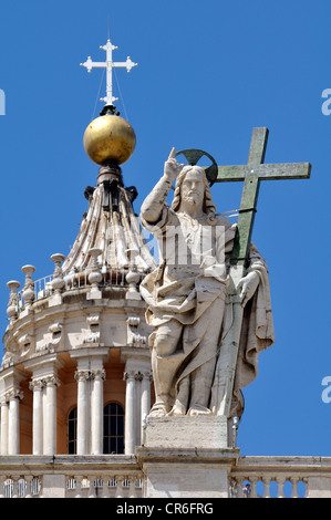 Statue of Jesus holding a cross above the colonnades, Basilica of Saint Peter, St. Peter's Basilica, Vatican City, Rome Stock Photo