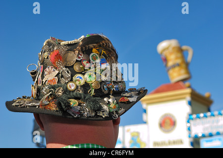 Traditional hat with many pins in front of the Paulaner beer tower, Oktoberfest 2010, Munich, Upper Bavaria, Bavaria Stock Photo