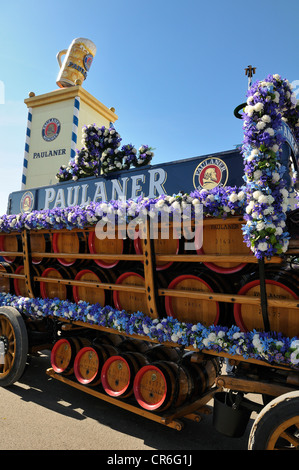Wood barrels from the Paulaner Brewery on a horse-drawn cart in front of the Paulaner beer tower, Oktoberfest 2010, Munich Stock Photo