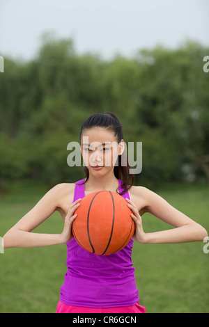 Young woman holding a basketball Stock Photo - Alamy