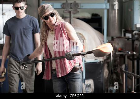 Caucasian woman in glass blowing studio Stock Photo