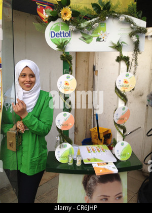 Egyptian Muslim Veiled employee Promoting a product in a supermarket Stock Photo