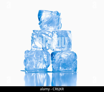 ice cubes shot on reflective white surface Stock Photo