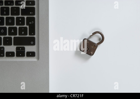 Laptop and padlock on white background Stock Photo
