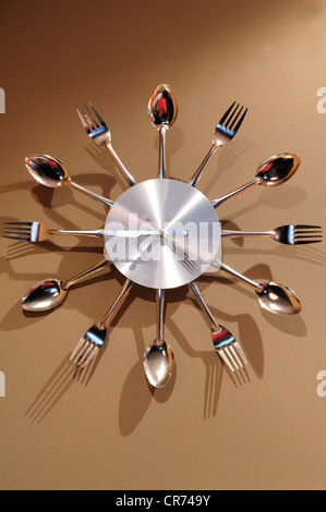 Wall clock made of cutlery on a wall Stock Photo