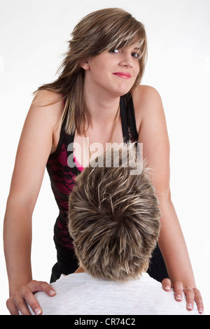 Young woman standing with her hand on man shoulder Stock Photo