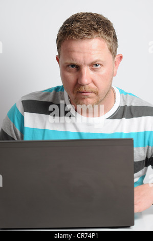 Studio shot of young man with notebook against the gray wall. Stock Photo