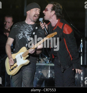 U2, Irish rock band, frontman Bono Vox is singing in the rain, half length, with guitarist The Edge, Olympic stadium, Munich, Germany, 2.8.2005, Stock Photo