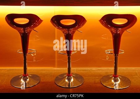 Three red plastic bar stools in front of a bar at a school of hotel management, Lycee Economique et Hôtelier Joseph Storck Stock Photo