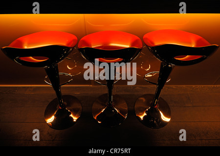 Three red plastic bar stools in front of a bar at a school of hotel management, Lycee Economique et Hôtelier Joseph Storck Stock Photo