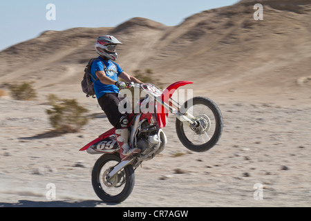 USA, California, Motocrosser performing wheelie on Palm Desert Stock Photo