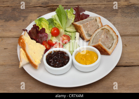 Picnic type food on a plate on a weathered wooden table Stock Photo