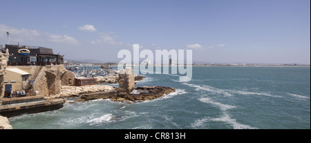Panoramic view showing a seaside restaurant, harbor, and Bay of Haifa in Acre, Israel Stock Photo