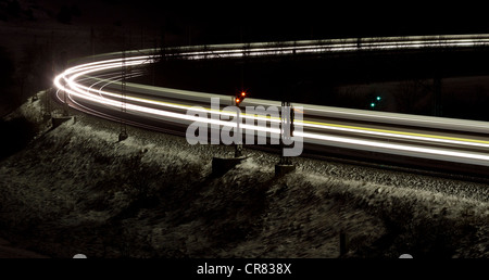 Train as a light trace in winter at night, Lonsee, Baden-Wuerttemberg, Germany, Europe Stock Photo