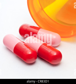 Red and Pink Pills with Prescription Bottle Stock Photo