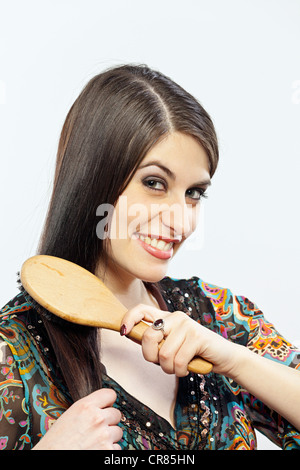 Young woman brushing her hair Stock Photo