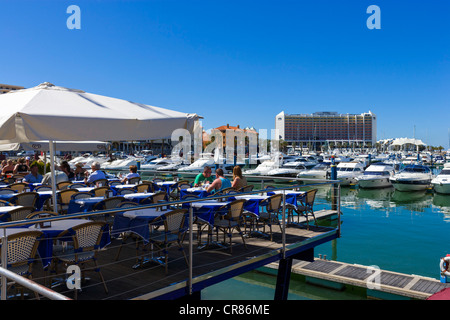 Restaurant terrace overlooking the marina in Vilamoura with the Hotel Tivoli in the background, Algarve, Portugal Stock Photo