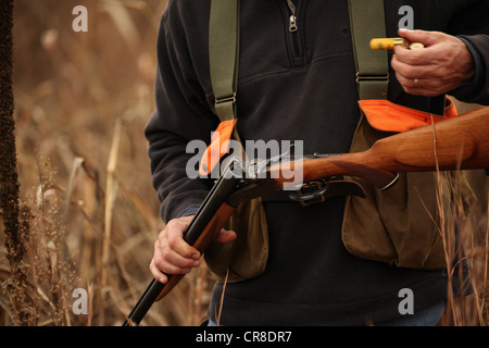 Hunter loading shotgun Stock Photo