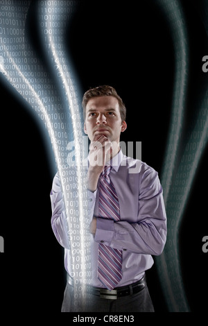 Businessman looking at data streams Stock Photo