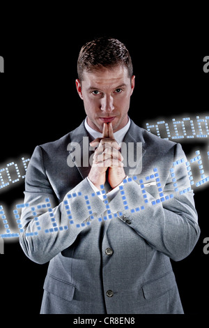 Businessman surrounded by ring of binary code Stock Photo