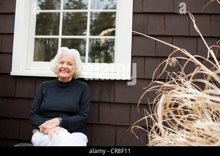 Portrait of senior woman outside house Stock Photo