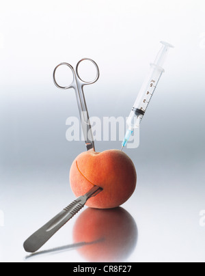 Peach and surgical instruments Stock Photo