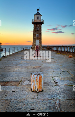 Whitby lighthouse and pier at sunset Stock Photo - Alamy