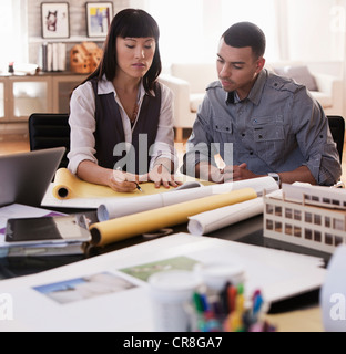 Architects discussing plans in studio Stock Photo