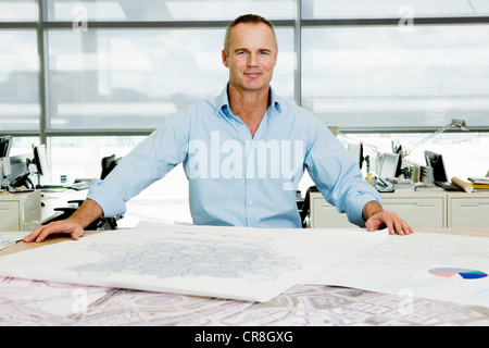 Portrait of an architect working on blueprints in office Stock Photo