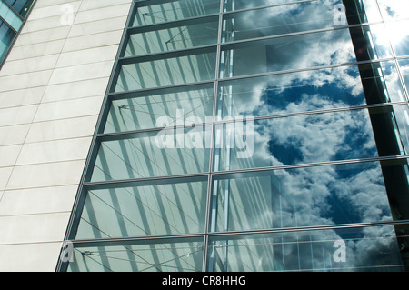 Cloudy blue sky reflected in office windows Stock Photo - Alamy