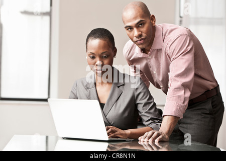 Two business colleagues using laptop Stock Photo