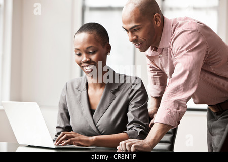 Two business colleagues using laptop Stock Photo
