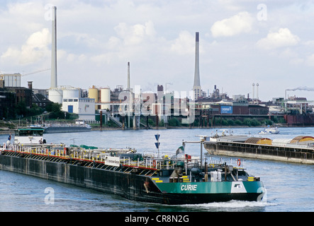 Shipping traffic on the Rhine River, industrial area at the back, Chempark Krefeld-Uerdingen industrial park, formerly known as Stock Photo