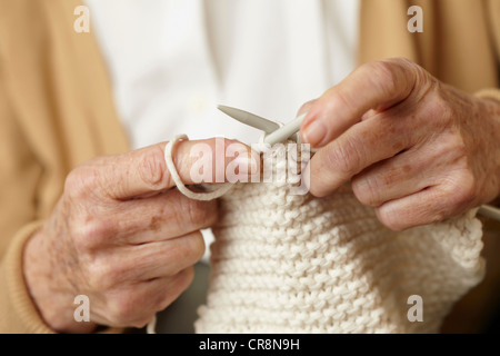 Close up older woman knitting, sitting on sofa at home Stock Photo - Alamy