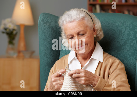 Senior woman knitting Stock Photo