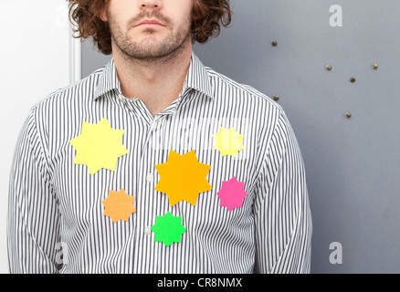 Office worker wearing adhesive notes on shirt Stock Photo