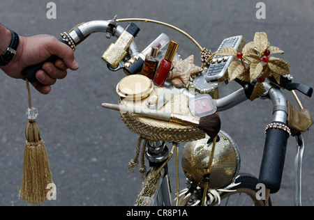 Handlebars of a ladies bicycle decorated with makeup and cell phone, Christopher Street Day in Duesseldorf Stock Photo