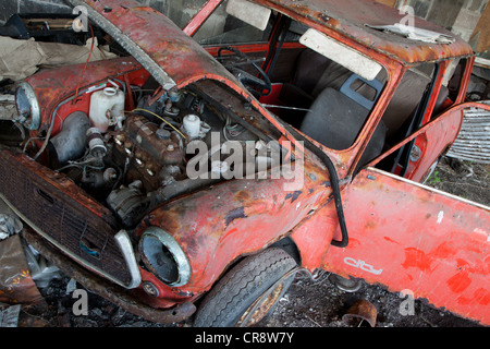 An abandoned old car in a workshop Stock Photo