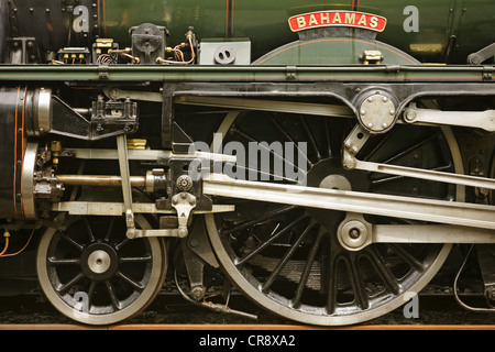 Nameplate and driving wheels of preserved LMS Jubilee Class steam locomotive 5596 'Bahamas'. Stock Photo