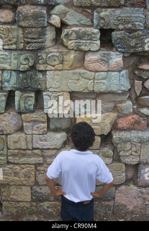 Student looking at Hieroglyph in Copan Ruins, Maya Site of Copan, UNESCO World Heritage site, Honduras Stock Photo