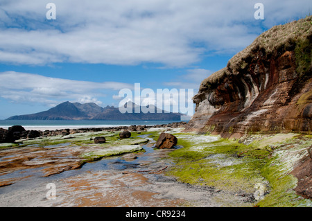 a landscape of bay of laig isle of eigg with good foreground interest and the isle of eigg in the back ground Stock Photo