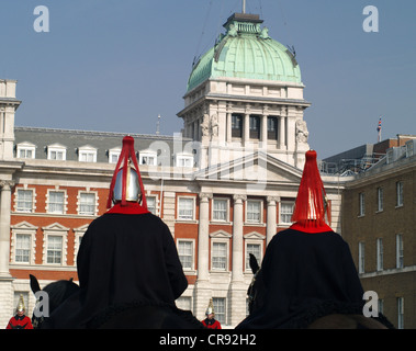 Two of the Mounted Regiment of The Household Cavalry, Queen's Life Guard, looking up at Horse Guards Parade buildings Stock Photo