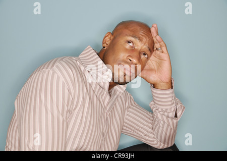 Portrait of an African American man with his head resting on his hand and eyes focused upward Stock Photo