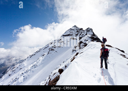 Hikers ascending Hintere Eggenspitze Mountain in Ulten Valley above ...