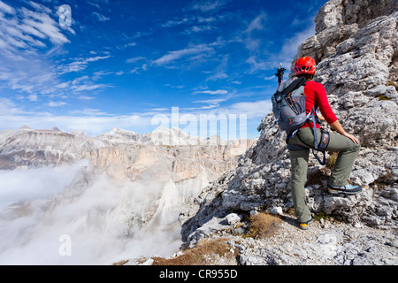 Climber climbing Gran Cir mountain via the fixed rope route above the Gardena Pass, Dolomites, Langental valley and Stevia fixed Stock Photo