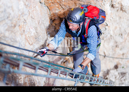 Mountaineer climbing on the Stevia fixed rope route, Langental valley, Val Gardena valley, Dolomites, province of Bolzano-Bozen Stock Photo