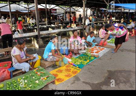 Vegetable sellers sitting on the ground selling betel nuts and chili peppers, Kota Biak, Biak Island, Irian Jaya Stock Photo